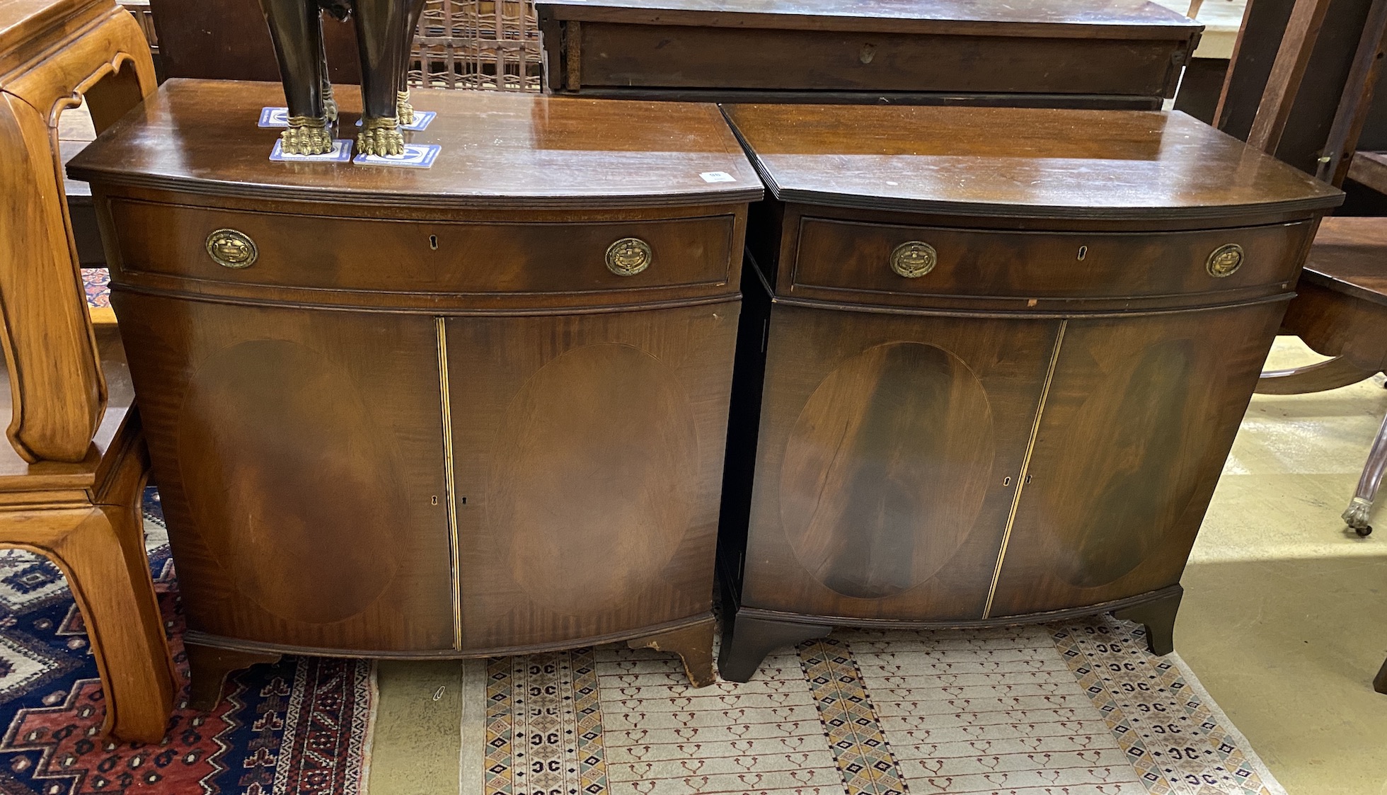 A pair of George III style mahogany bow front side cabinets, width 83cm, depth 50cm, height 86cm